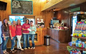 Elizabeth Reed, Kayla Watkins, Christie Cox, Brittany Thomasson of Apples for Teachers presenting check to Michelle Cobern, Executive Director of CASA of Titus, Camp and Morris Counties in the amount of $724.76 representing 10% of coffee sales and all tips during the month of April. 